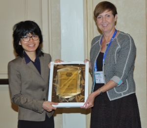 Yimon Aye receiving the CRT Young Investigator Award award from Judy Bolton